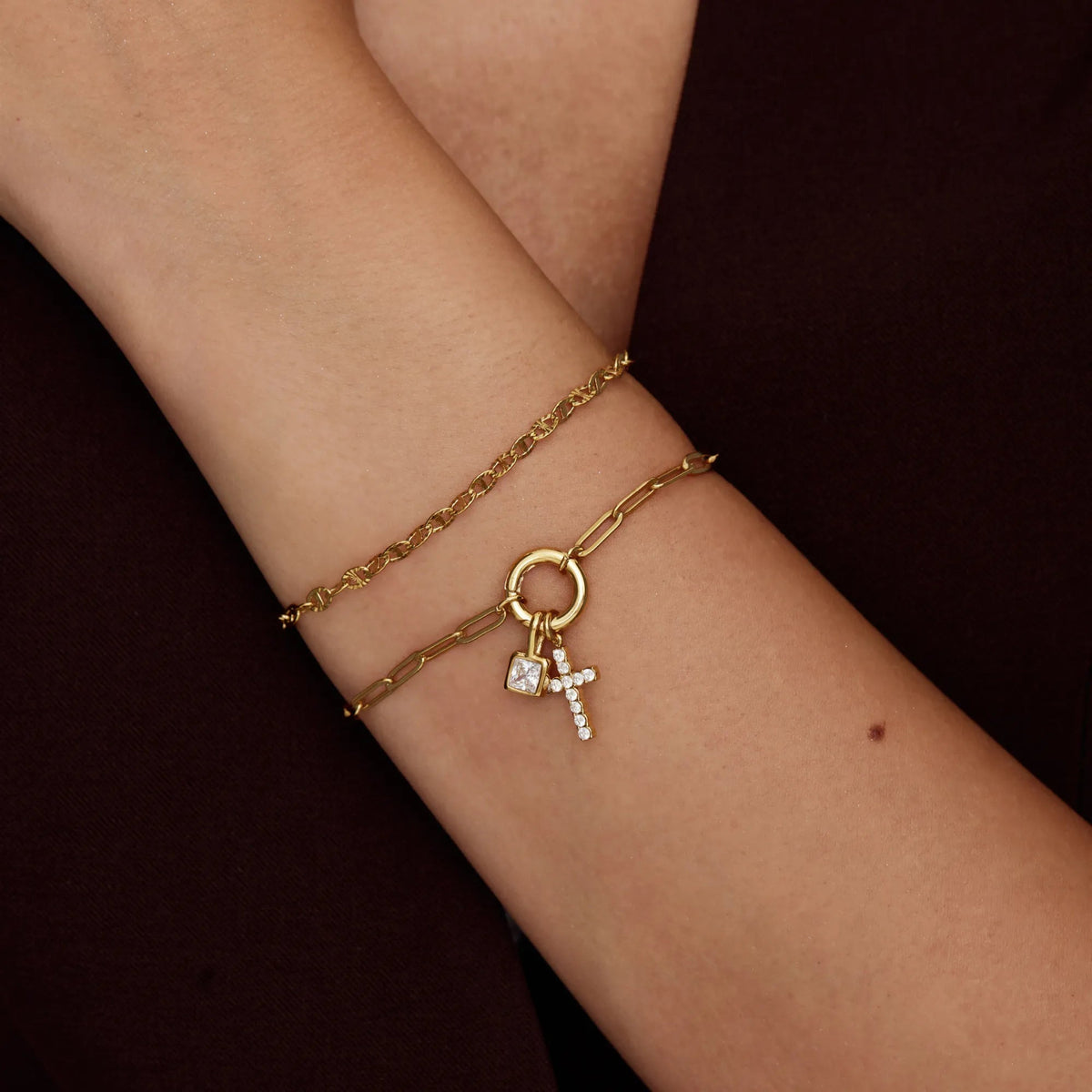 Gold birthstone cross bracelet worn