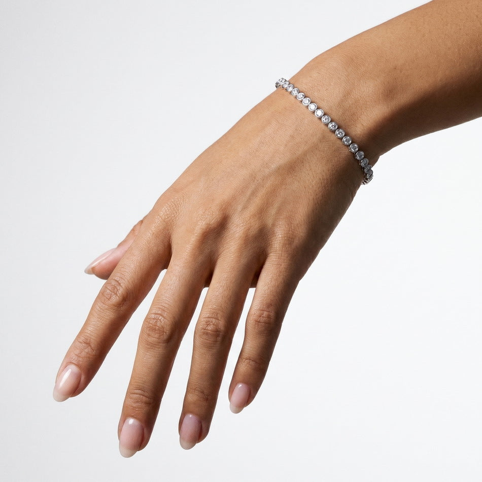 Bezel lab diamond tennis bracelet worn on the wrist