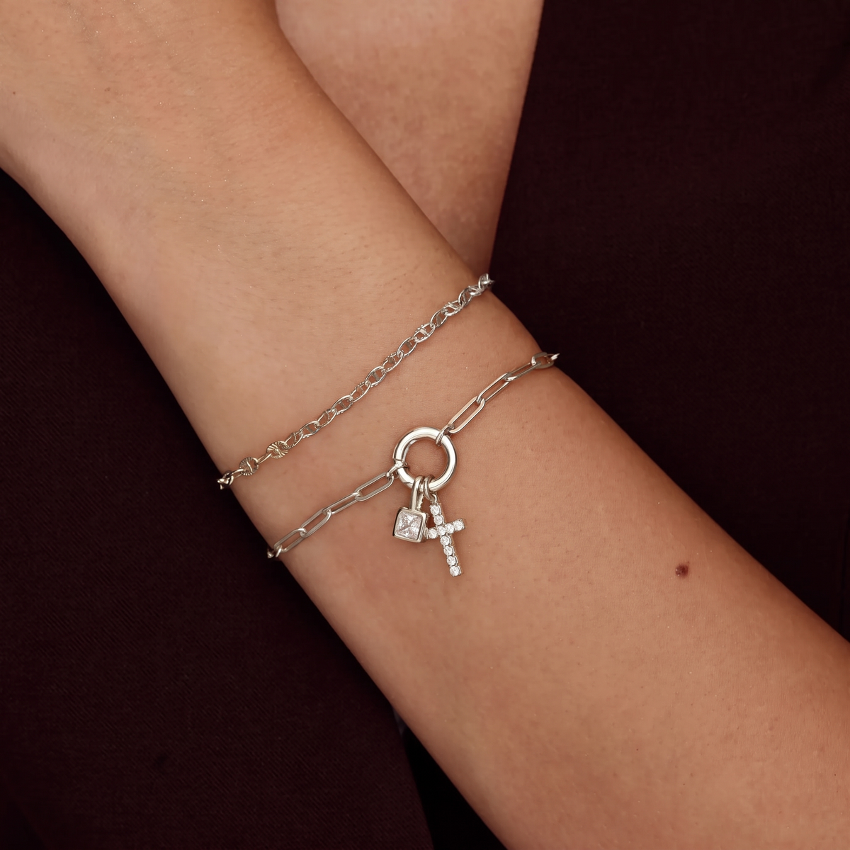 Silver birthstone cross bracelet worn