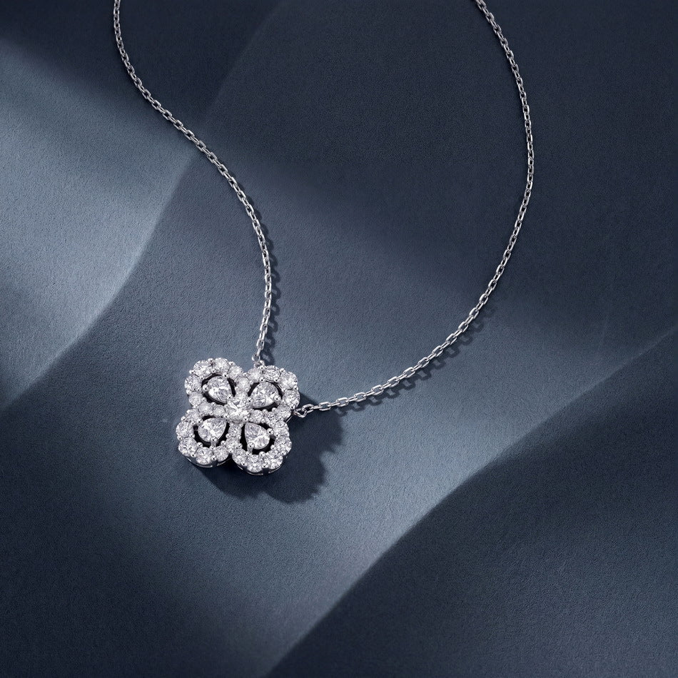 Lab diamond clover pendant up close on silk