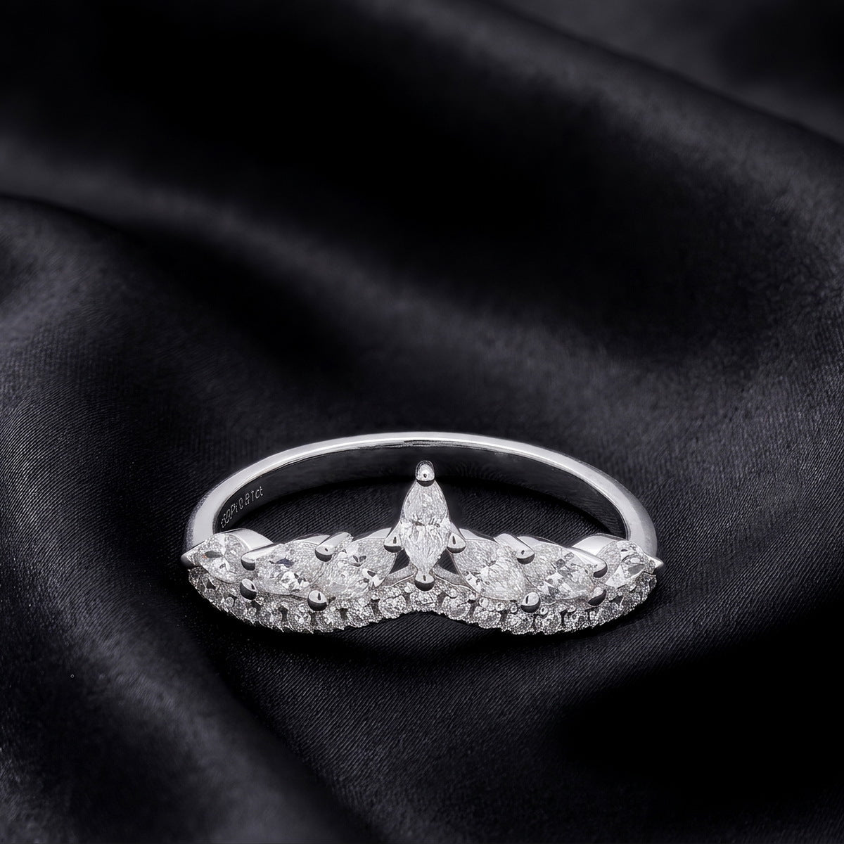 Crown ring on black satin, front