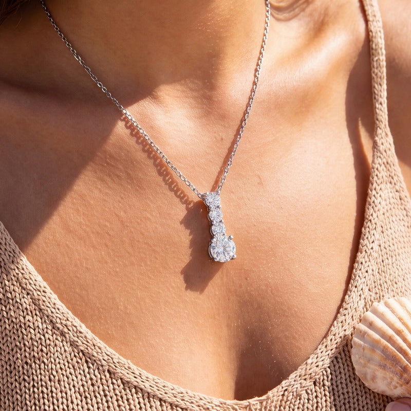 Graduated drop pendant worn close up