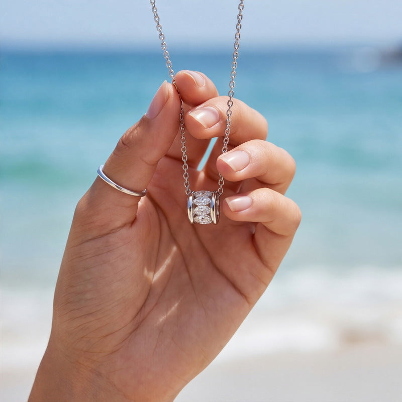 Marquise barrel necklace held in the hand