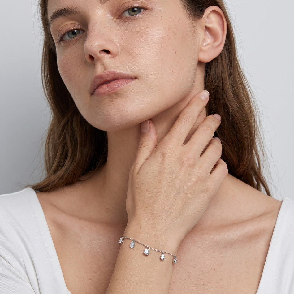 Model wearing the mixed-shape charm bracelet