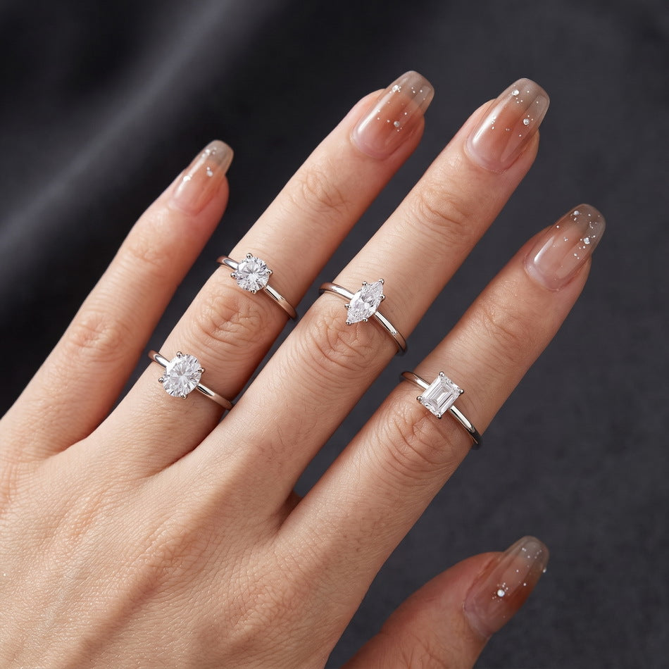Solitaires in four shapes worn on the hand (oval shown bottom left)