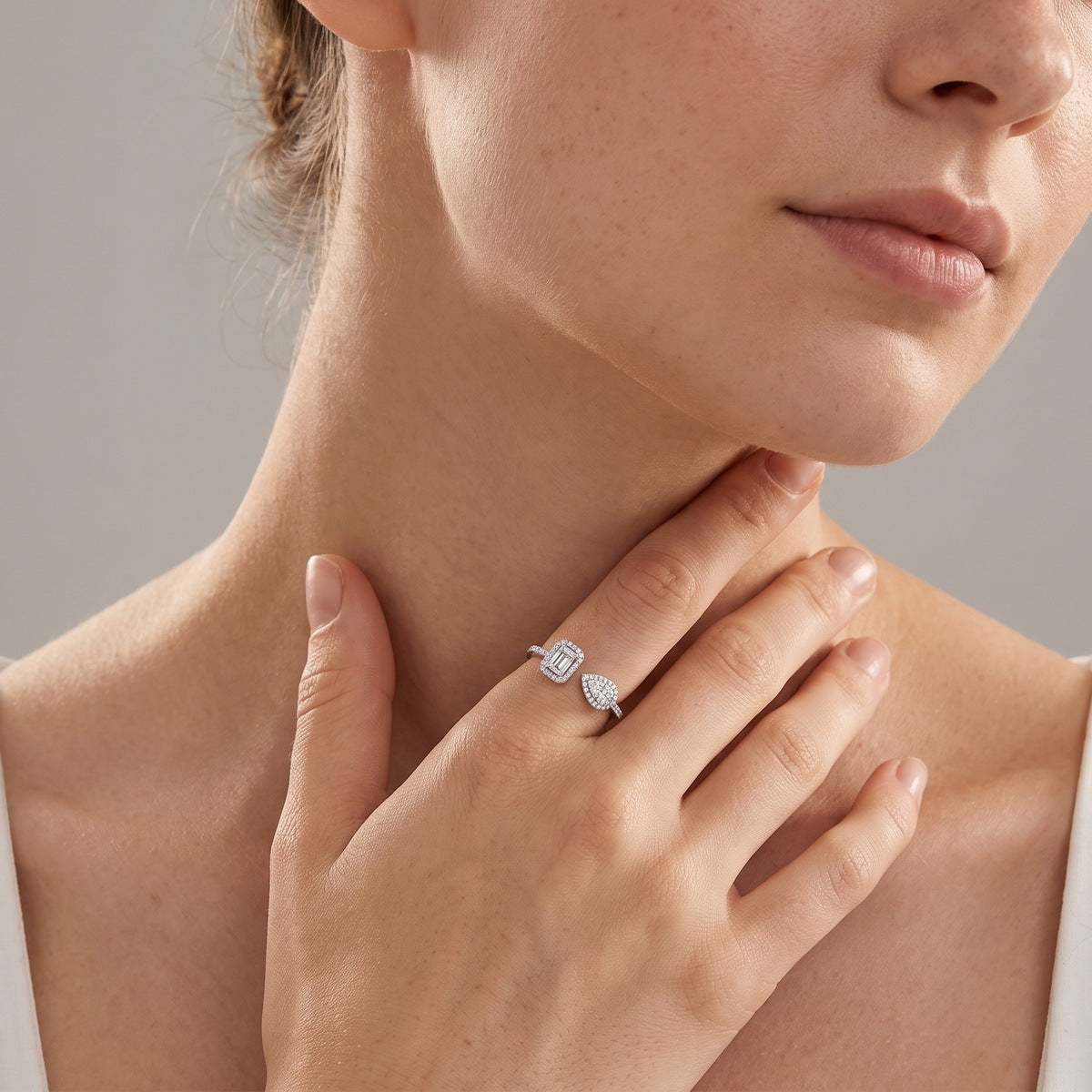 Model wearing the pear & emerald open ring
