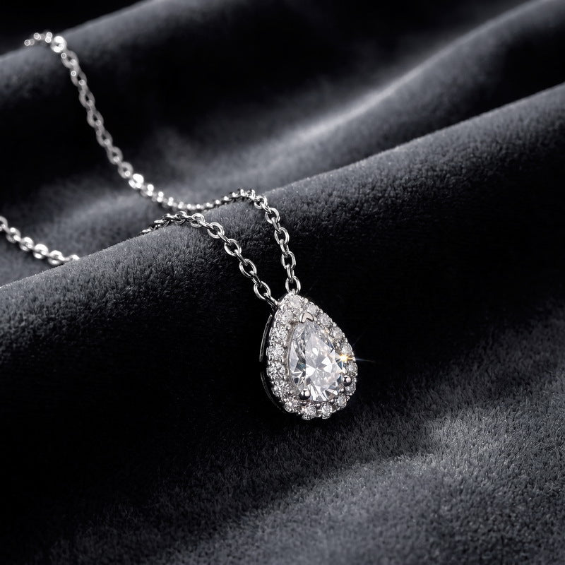 Pear halo pendant on dark velvet