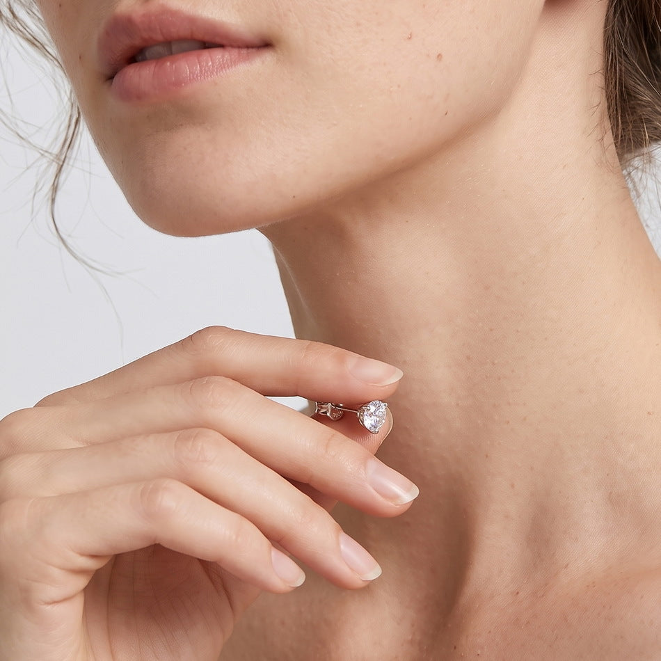 Model holding the stud earring