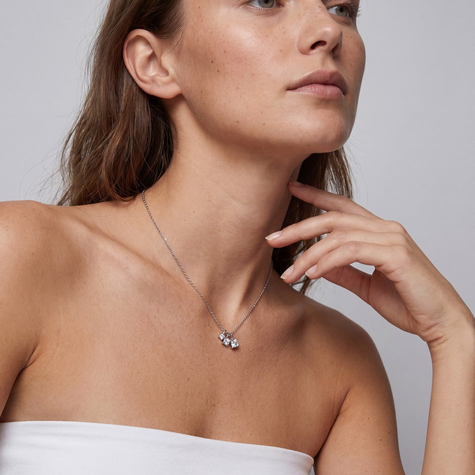 Model wearing the three-stone cube necklace