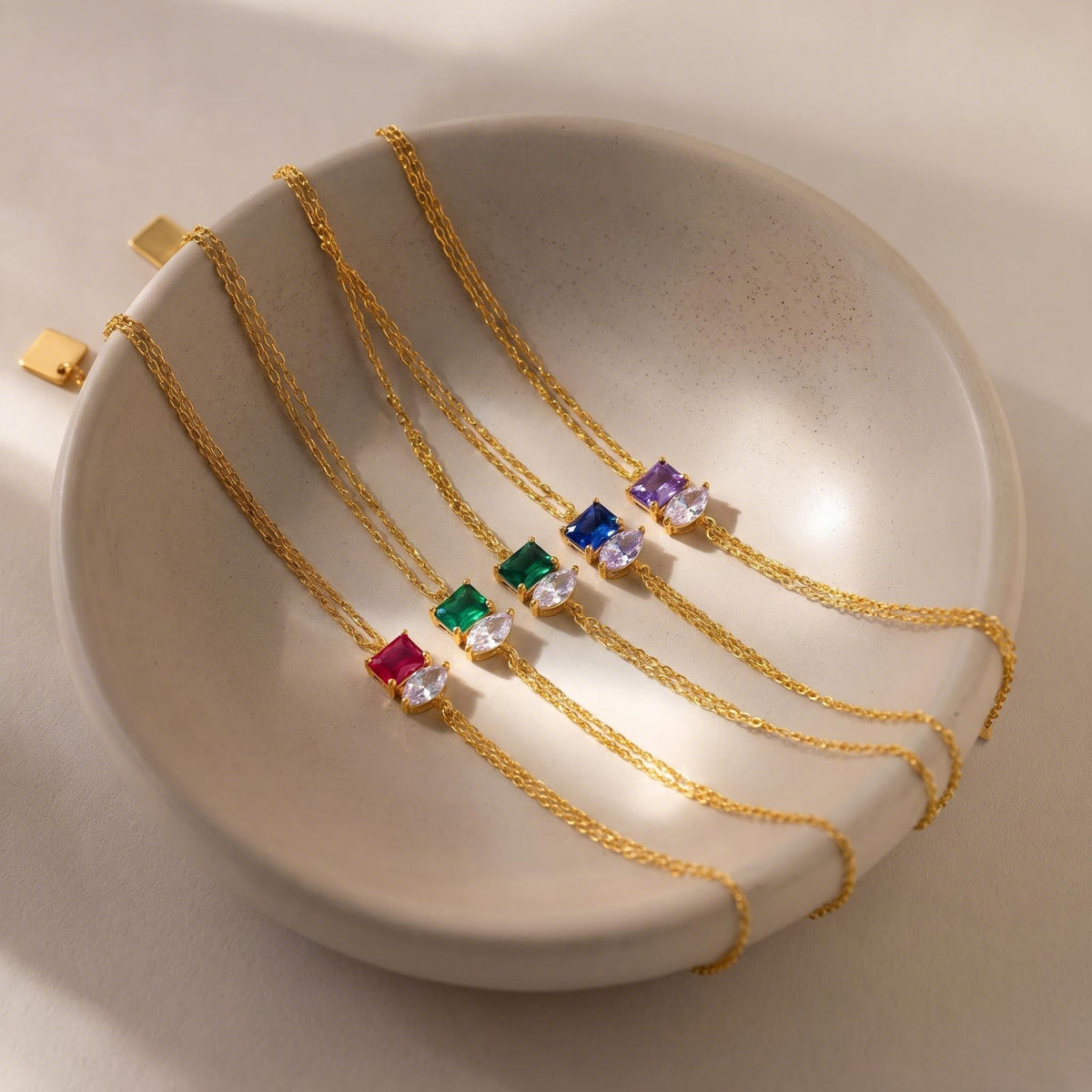 Marquise Birthstone Bracelets in a ceramic dish