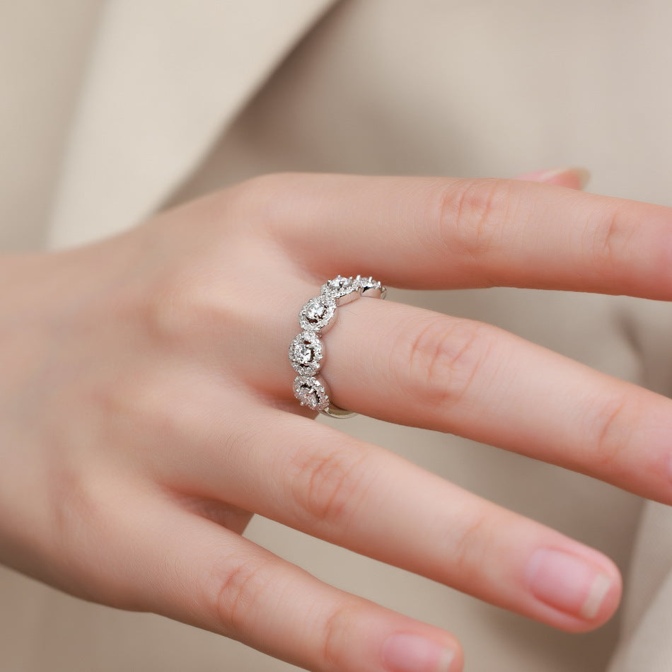 Halo five-stone ring worn on the hand