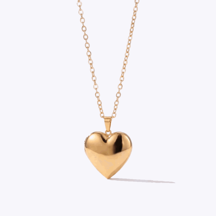 Gold photo heart locket opening to show family photos