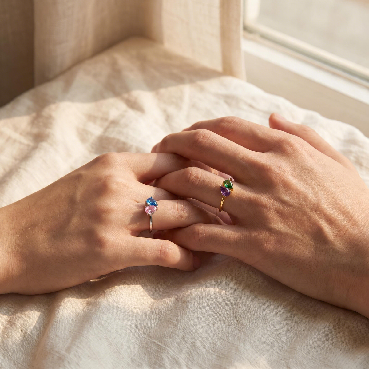 Together birthstone rings on two hands